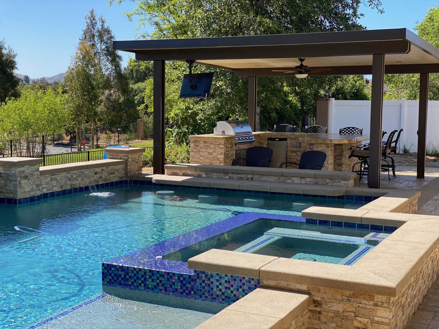 Outdoor patio with wooden pergola and wicker furniture — aluminum cover installation
