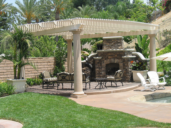 White pergola with lattice columns in front of a house